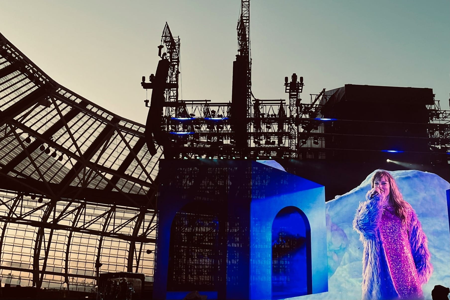A woman standing on a stage in front of a building